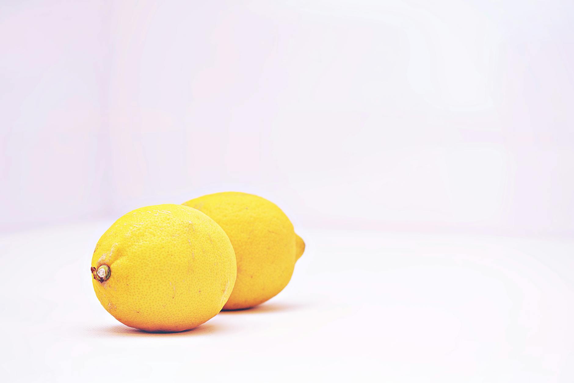 Two vibrant lemons on a white background symbolizing freshness and renewal