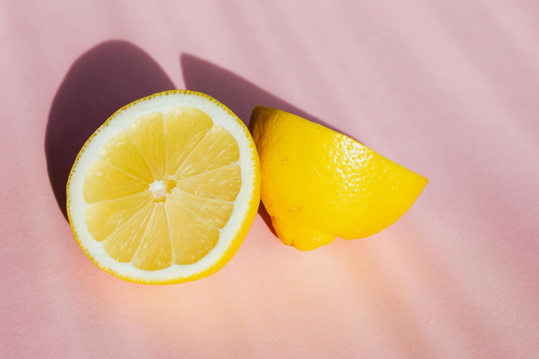 Two smiling women celebrating joy together with lemon slices