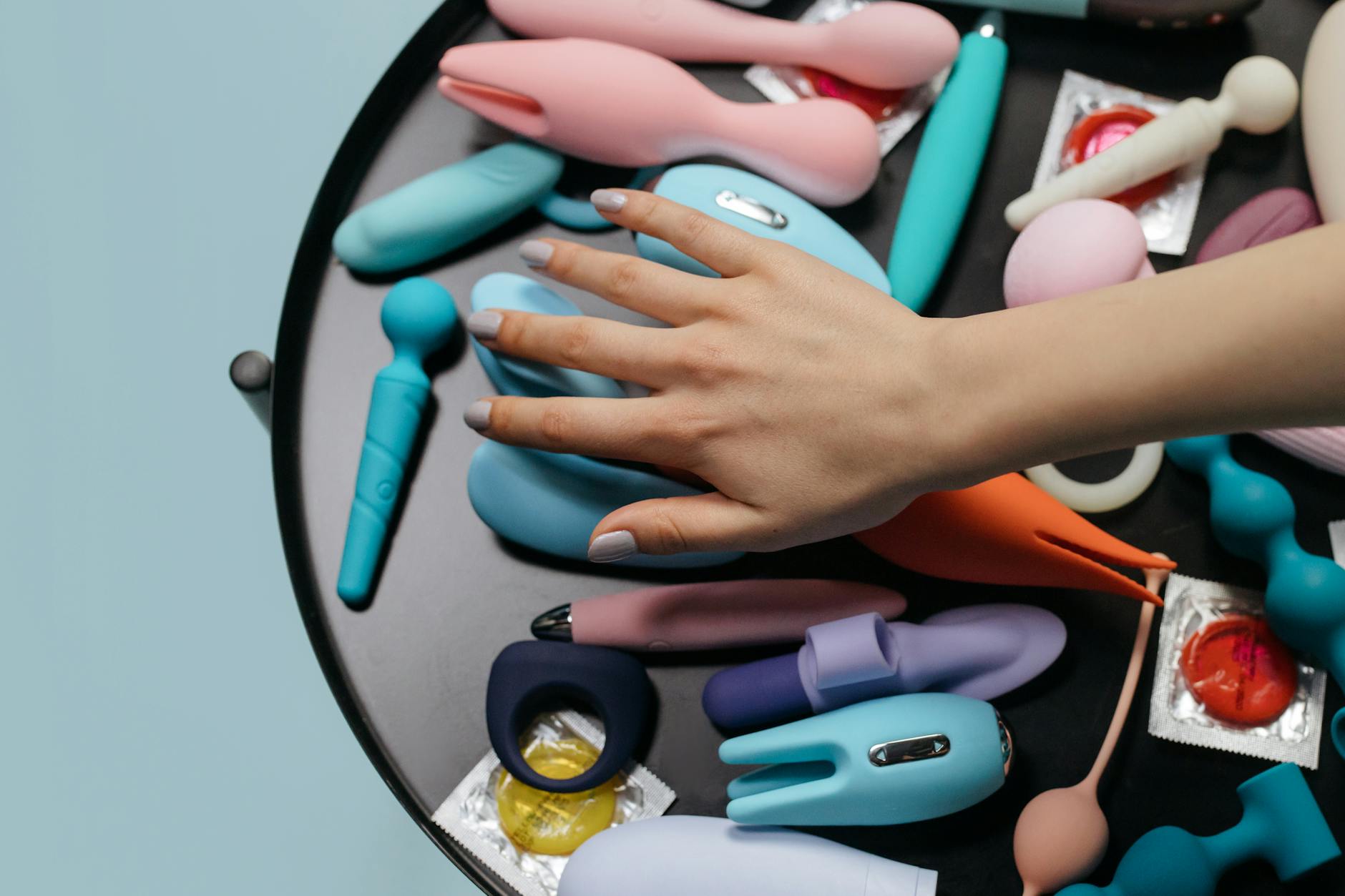 Woman holding lemon clitoral vibrator and considering postpartum pleasure options